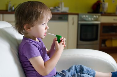 Little boy using inhaler clipart