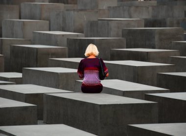 Woman sitting on monument stone clipart