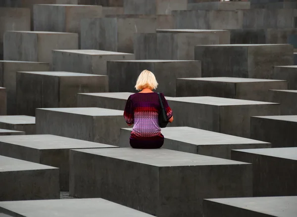 stock image Woman sitting on monument stone