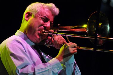 Trombonist from Pink Martini band performs live on the stage clipart