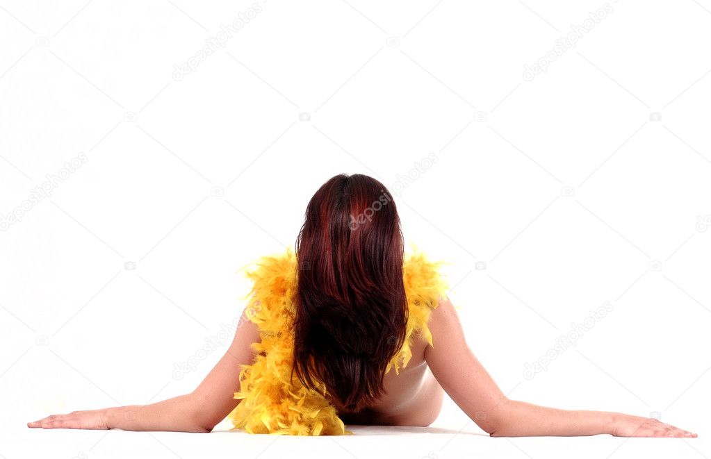 Naked woman with yellow feathers scarf laying down on white back