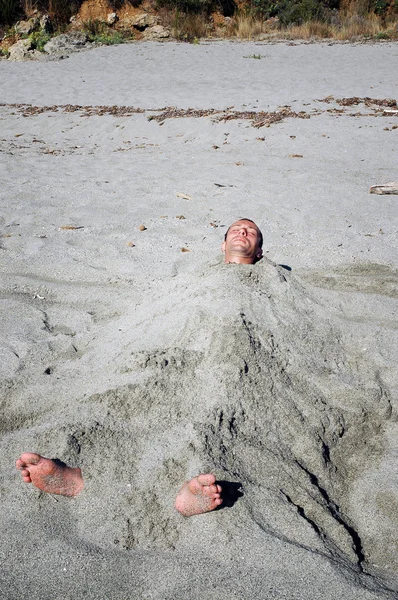 Man covered by sand on the beach — Stock Photo, Image