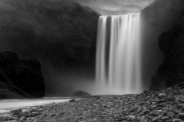 Skogafoss waterfall at night clipart