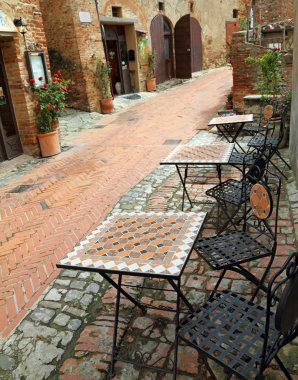 Garden furniture on italian narrow street i clipart