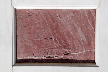 Antique red marble slab framed with white marble clipart