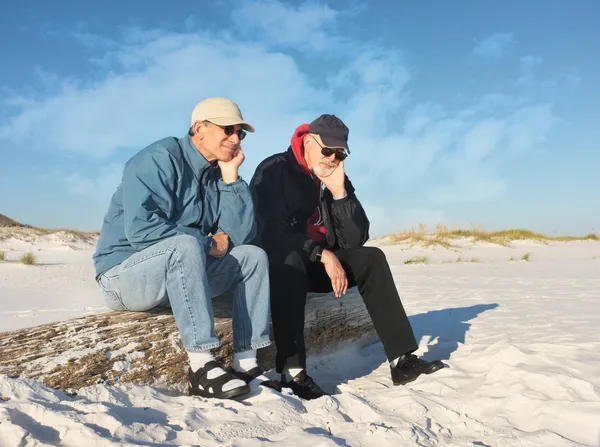 Dos aburridos jubilados sentados en la playa — Foto de Stock