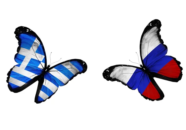 Conceito - duas borboletas com bandeiras gregas e russas voando — Fotografia de Stock