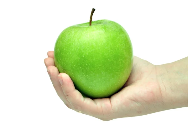 Groene appel in een hand — Stockfoto
