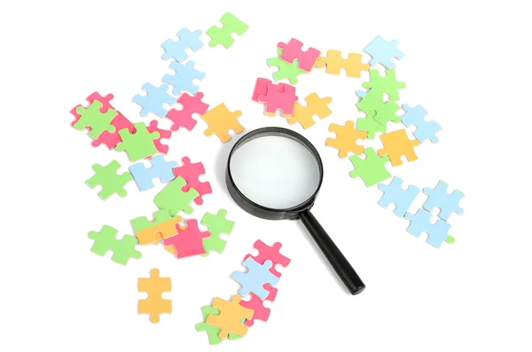 Puzzle and magnifier — Stock Photo, Image