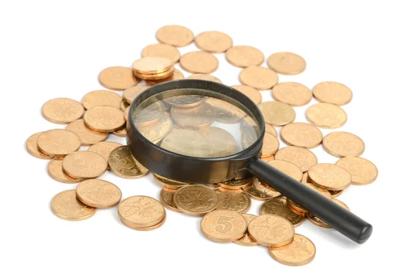 Coins and magnifier — Stock Photo, Image