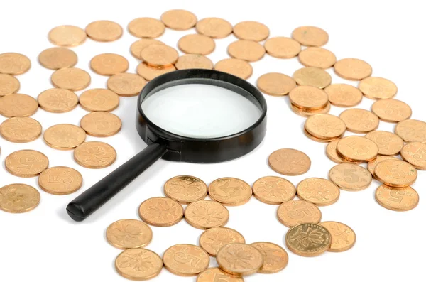 Coins and magnifier — Stock Photo, Image