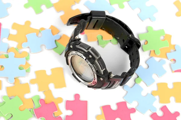 Puzzle and digital watch — Stock Photo, Image