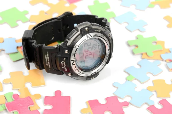 Puzzle and digital watch — Stock Photo, Image