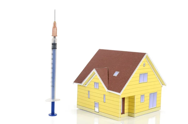 Syringe and model house — Stock Photo, Image