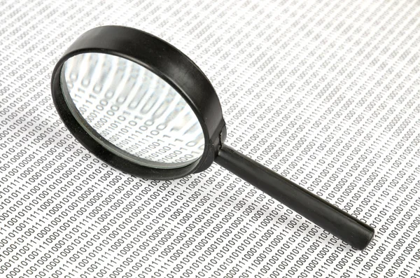 Binary code and magnifier — Stock Photo, Image