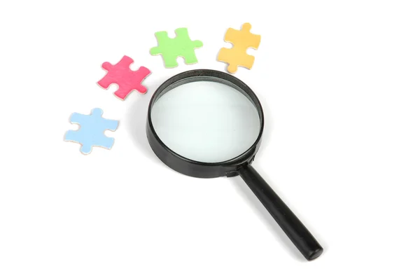 Puzzle and magnifier — Stock Photo, Image