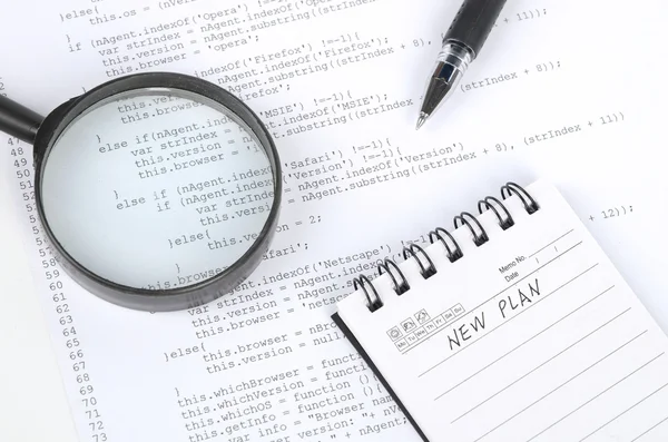 Html page and notepad with magnifier — Stock Photo, Image