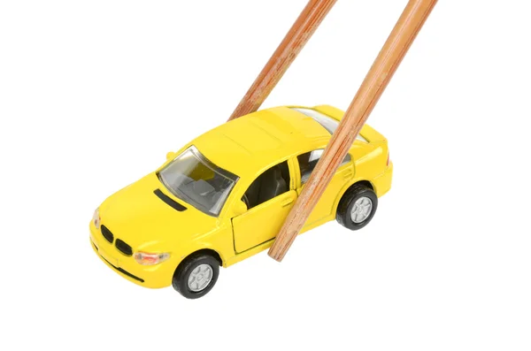 Carro de brinquedo e pauzinhos — Fotografia de Stock
