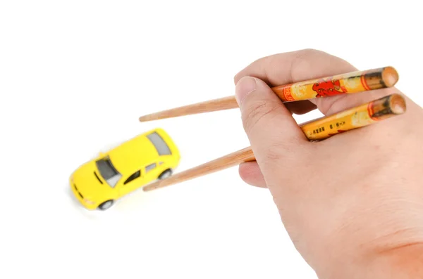 Speelgoedauto en eetstokjes — Stockfoto