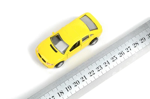Steel ruler and toy car — Stock Photo, Image