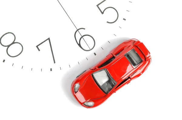 Toy autó és a óra szembenéz — Stock Fotó