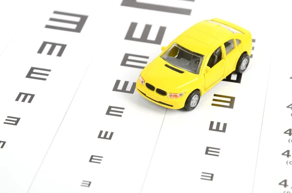 Toy car and eyesight chart — Stock Photo, Image