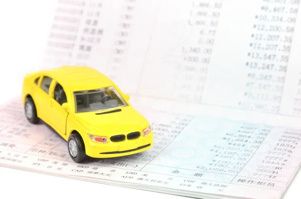 Toy car and bankbook — Stock Photo, Image