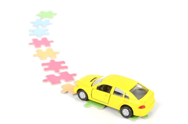 Puzzel en speelgoed auto — Stockfoto