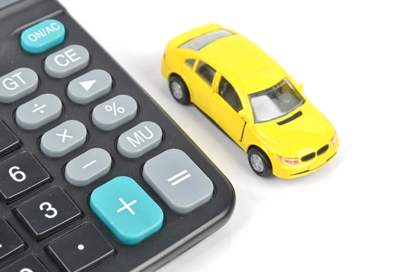 Игрушечный автомобиль и калькулятор — стоковое фото
