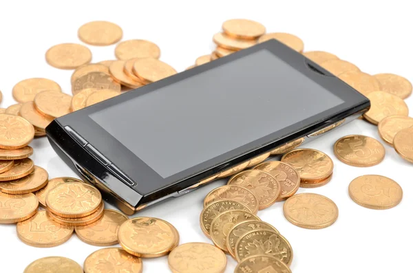 Chytrý telefon a mince — Stock fotografie