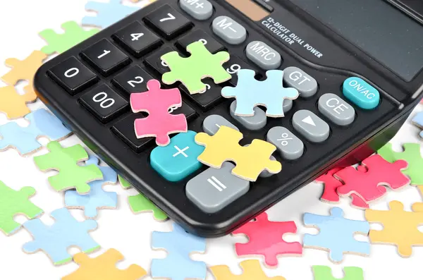Puzzle and calculator — Stock Photo, Image