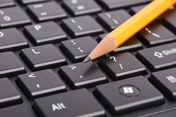 Computer keyboard and pencil