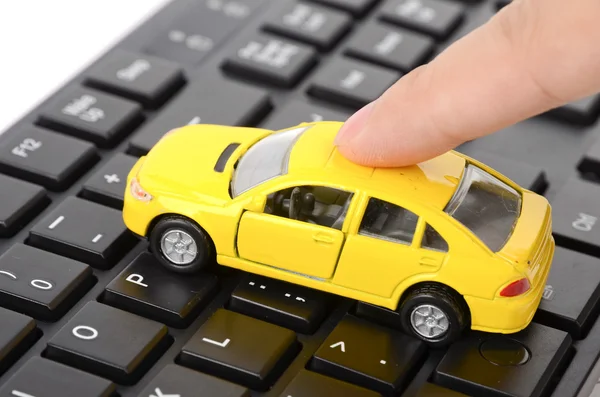 Computer keyboard and toy car — Stock Photo, Image