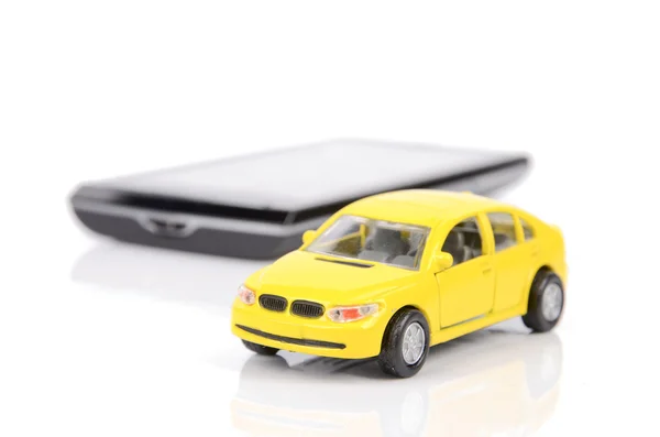 Carro de brinquedo e telefone inteligente — Fotografia de Stock