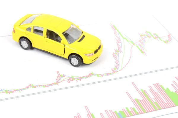 Toy car and financial graph Stock Picture
