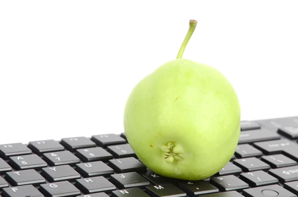 Pear and computer keyboard — Stock Photo, Image