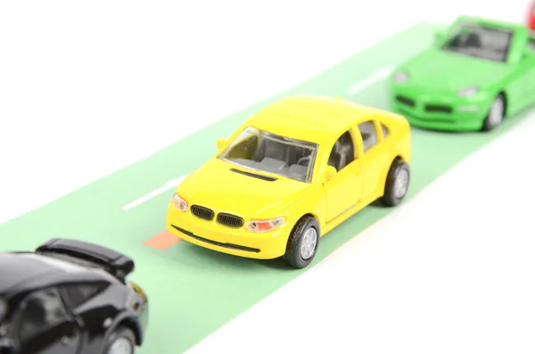 Carros de brinquedo na estrada — Fotografia de Stock