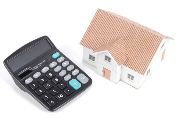 Calculator and model house — Stok fotoğraf