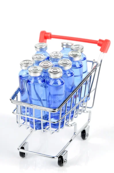 Nákupní vozík a lahvičky — Stock fotografie