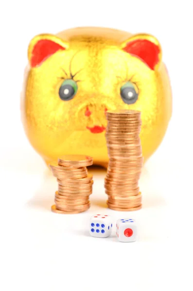 Piggy bank and coins with dices — Stock Photo, Image