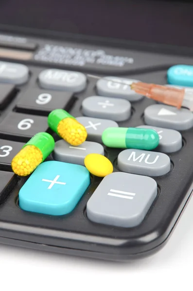 Medicine and calculator Royalty Free Stock Images