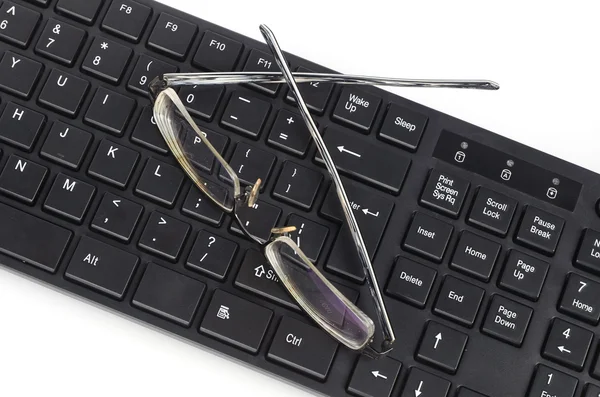 Tastiera per computer e occhiali — Foto Stock