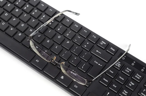 Počítačové klávesnice a oko brýle — Stock fotografie