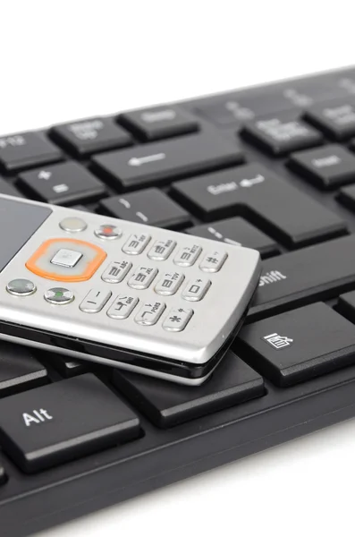 Cellphone and computer keyboard — Stock Photo, Image