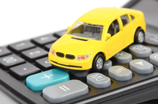 Kalkulačka a hračka auto — Stock fotografie