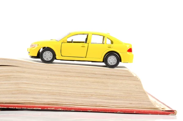 Stock image Toy car and dictionary