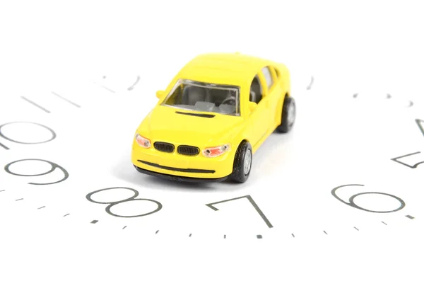 Speelgoed auto en klok gezicht — Stockfoto