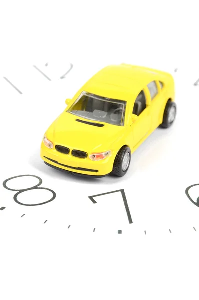 Toy autó és a óra szembenéz — Stock Fotó