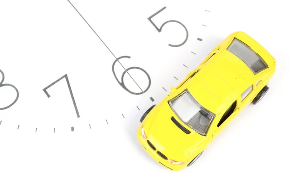 Toy car on clock face — Stock Photo, Image