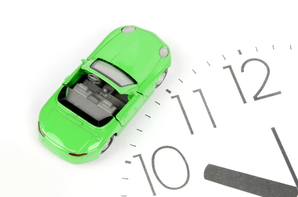 Toy car on clock face — Stock Photo, Image